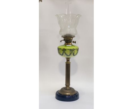 An Edwardian cast brass and glass oil lamp, the circular lacquered base under a reeded column supporting a green glass reserv