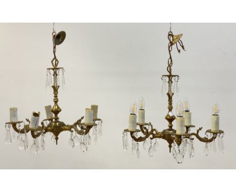 A pair of floral cast gilt brass chandeliers, first half of the 20th  century, each with a faceted central step issuing five 