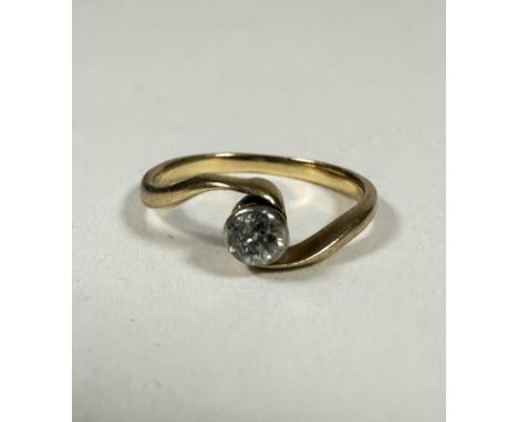 A 18ct gold solitaire Diamond ring in rubover setting on cross over band,  0.20ct approximately, H. 1.56g