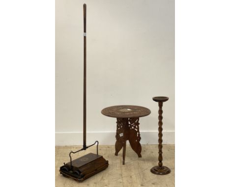 An eastern style carved hardwood occasional table, the circular top with simulated bone inlay raised on a folding tripod supp