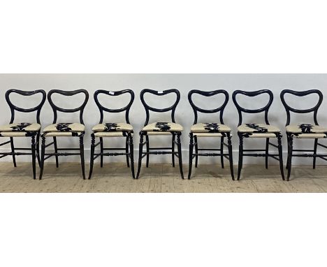 A set of seven Victorian ebonised dining chairs, with open kidney backs over upholstered seats and horse hair filled squab cu