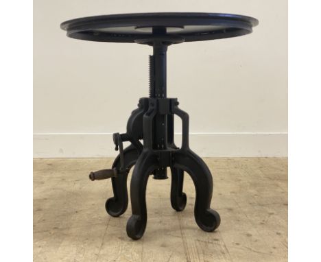 An unusual Industrial style cast iron lamp or bistro table, the circular revolving top above a winding handle and four splaye