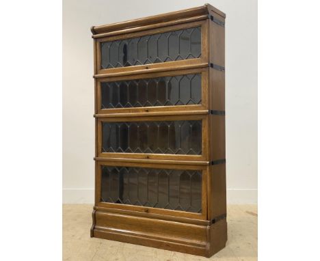 Globe Wernicke, an early 20th century oak four height stacking library bookcase, each tier with lead glazed up and over doors