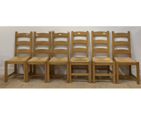 A matched set of six beech framed farmhouse style ladder back dining chairs, with paper cord seats, raised on square section 