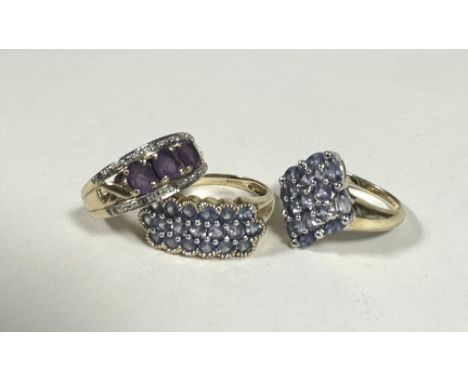 A 9ct gold QVC navette shaped lavender coloured stone cluster ring, M,  a 9ct gold QVC triple row lavender coloured stone set