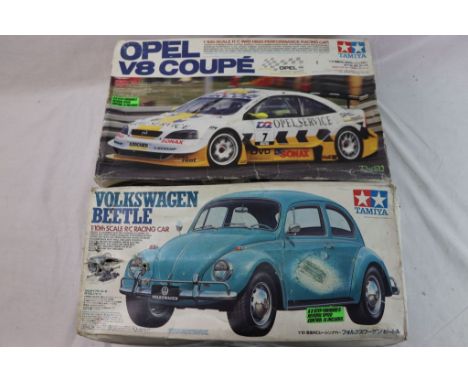 Two boxed Tamiya 1/10th scale remote control cars to include a Volkwagen Beetle and an Opel V8 Coupe 4WD high performance rac