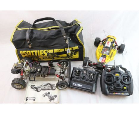 A 1/10th scale Kyosho Optima 4WD off road remote control racing car together with a spare rolling chassis for spares, to also