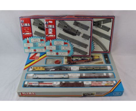 Boxed Lima OO gauge 106705TG train set complete with locomotive and 7 items of rolling stock plus 3 x boxed Lima track packs 