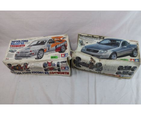 Two boxed 1/10th scale Tamiya remote control cars to include a Repsol Ford Escort RS Cosworth and a Mercedes Benz SLK Kompres