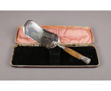 A cased silver mounted horn handled crumb scoop. Assayed in Sheffield 1906 by Walker &amp; Hall.  