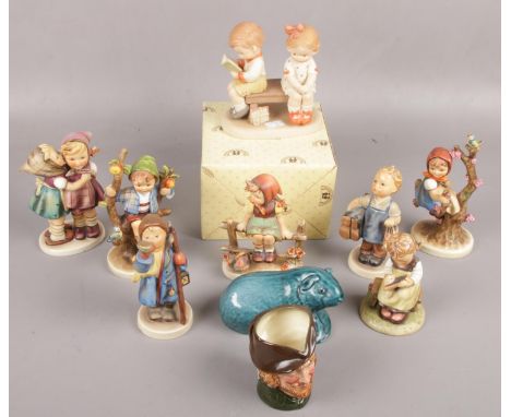 A quantity of mostly Goebel hummel figures to include boy carrying shoes, figures sat on branches, Royal Doulton Robin Hood c