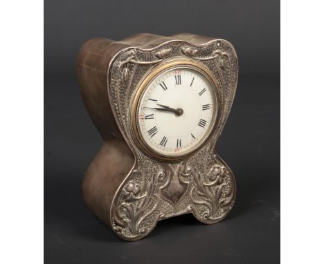 An Art Nouveau silver cased desk clock by Douglas Clock Co. Decorated in relief with stylized flowers on a stipple ground. Ho