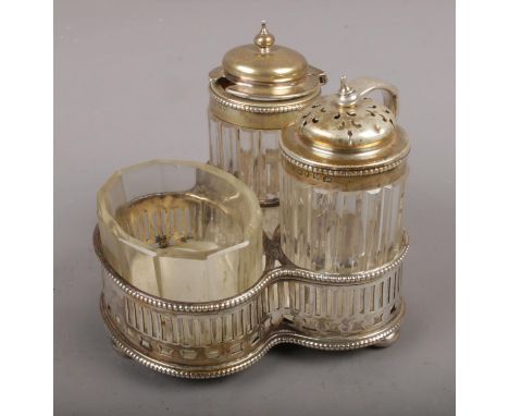 An assembled Victorian silver and glass cruet set, the stand assayed Sheffield 1865 by Martin, Hall &amp; Co.  