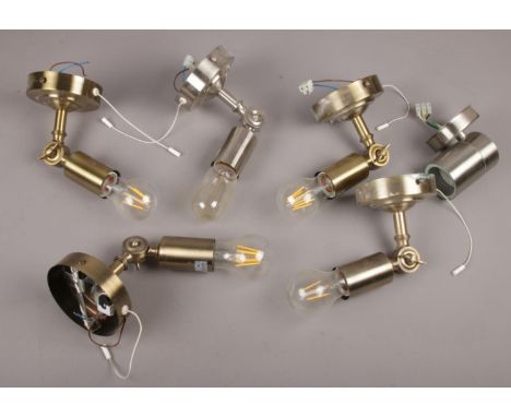 A box of brushed chrome pull chord wall light fittings with filament blubs.  