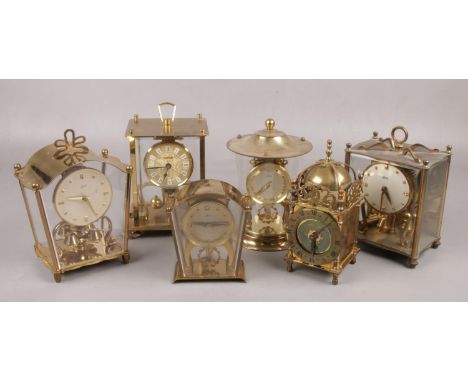 Six brass clocks, to include torsion examples, Schatz two jewel, Smiths lantern clock etc.  