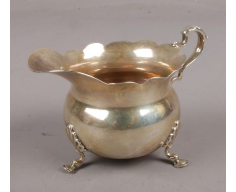 A George V silver cream jug assayed Birmingham 1910 by William Aitken. (104g).  