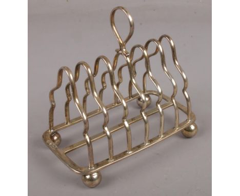 A silver seven bar toast rack assayed Sheffield 1911, by Martin, Hall &amp; Co. (165g).  