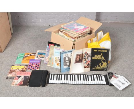 A Roll-up Piano with instructions and Piano and keyboard CD-Rom Piano workshop, together with a large collection of music ins