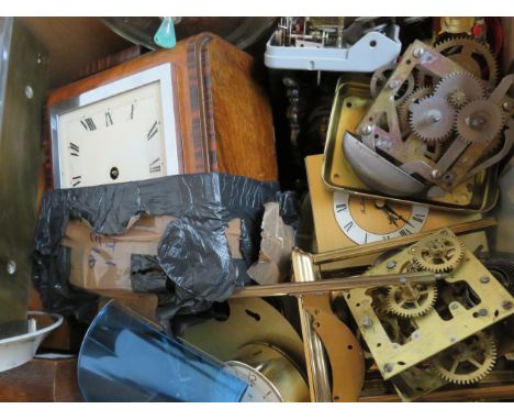 A box of clock parts for spares and repair