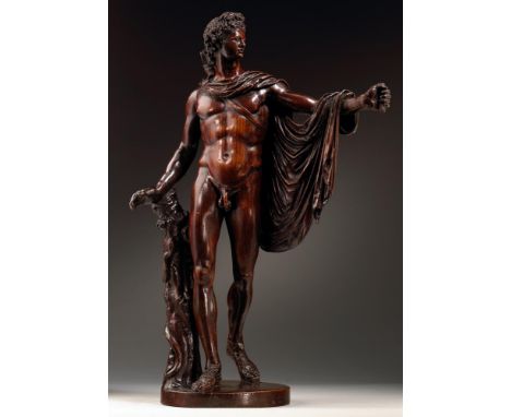 AFTER THE ANTIQUE- A CARVED FRUITWOOD FIGURE OF THE APOLLO BELVEDERE  ITALIAN, 17TH/18TH CENTURY On an integrally carved circ