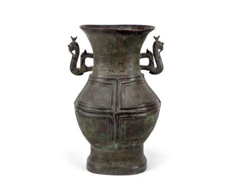 A LARGE CHINESE BRONZE BALUSTER VASE IN THE ARCHAIC STYLE  SONG-MING DYNASTY  Twin dragon handles flanking body with relief b