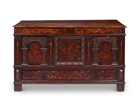 A CARVED OAK, FRUITWOOD AND MARQUETRY CHEST 17TH CENTURY  With a hinged plank top above a strapwork-inlaid frieze rail and th