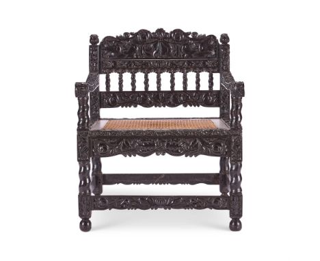 Y&nbspAN INDIAN SOLID EBONY ARMCHAIR COROMANDEL COAST, LATE 17TH CENTURY  Of typical form, boldly carved throughout with flow