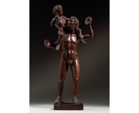 A CARVED BOXWOOD FIGURE OF A SATYR WITH YOUNG BACCHUS  ITALIAN, 18TH CENTURY  Old inscription to base "Infant Pan Early Itali