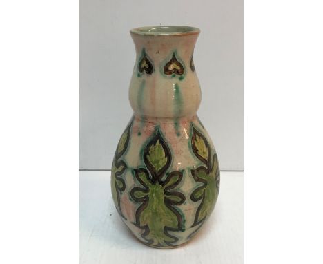 A Della Robbia stylised gourd shaped vase decorated by Cassandra (Cassie) Annie Walker with stylised relief decoration bearin