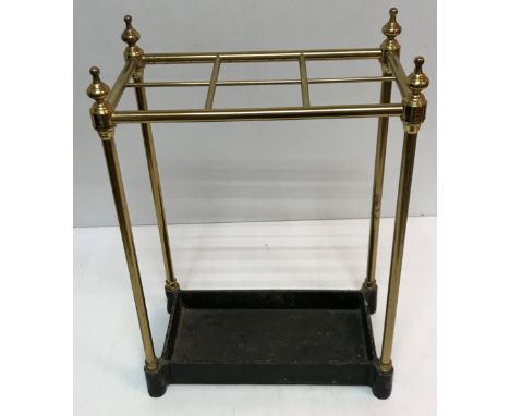 A brass and cast metal six section stick stand, the base stamped "Made in England JANS225", 42 cm wide x 23 cm deep x 60 cm h