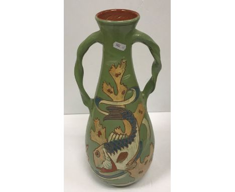 A C H Brannam Barum ware pottery vase of baluster form with incised fish decoration on a pale green ground, No'd. to base “12