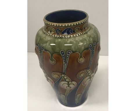 A Frank A Butler Royal Doulton baluster shaped vase with Gothic style relief work foliate decoration, bearing monogram to bas