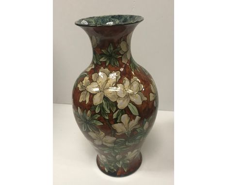 A Royal Doulton faience ware baluster shaped vase with all-over floral design, initialed to base “MB” for Mary Butterton, 37.