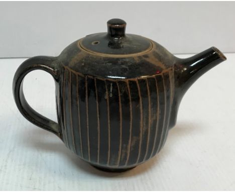 A David Leach treacle glazed teapot with cut sided design 16.5 cm high