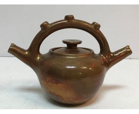 An Elton ware copper lustre twin-spouted teapot 17.5 cm high CONDITION REPORTS Crazing throughout.  There is some damage to t