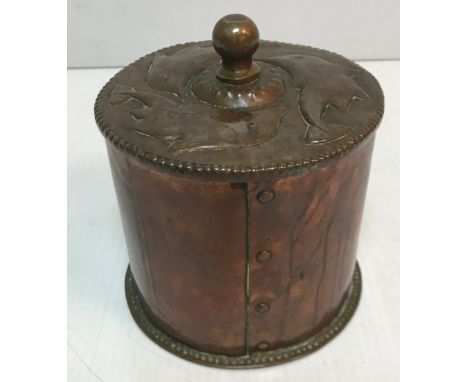 A John Pearson Newlyn School cylindrical biscuit barrel / jar and cover with stylised dolphin decoration lid, bearing initial