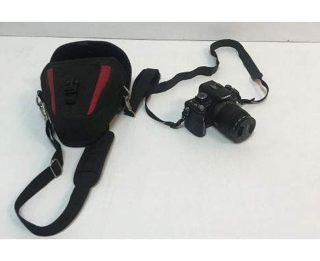 A Panasonic Lumix DMC-G2 camera with a 14-42 lens, instructions, charger and strap together with a Marks &amp; Spencers "Harv