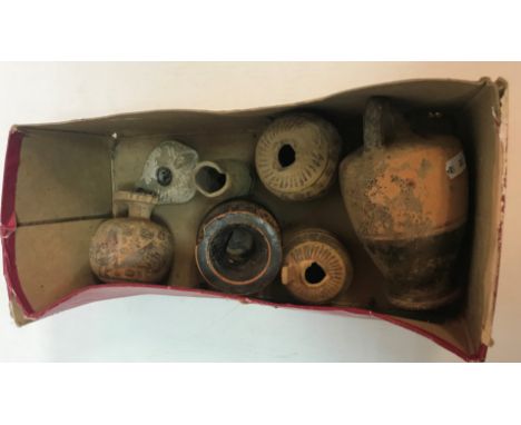 A box containing assorted Roman/Etruscan pottery vessels to include an oil lamp etc the tallest flagon approx. 15.5 cm high