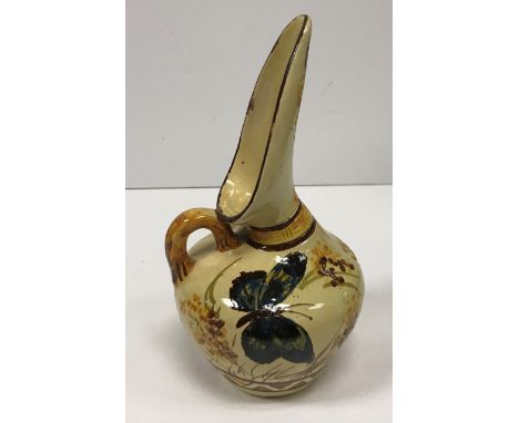 A William Ault Pottery ewer designed by Christopher Dresser with butterfly and floral decoration probably painted by Clarissa