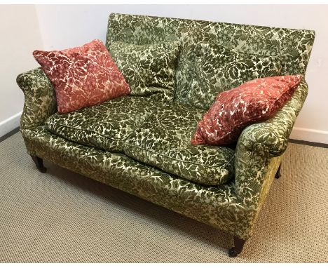 An Edwardian upholstered scroll arm two seat sofa on square tapered mahogany legs to casters 142 cm wide x 82 cm deep x 79 cm