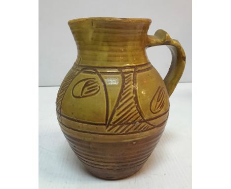 A Ray Finch Winchcombe Pottery brown and ochre glazed jug with incised decoration, bearing initials / monogram stamp "RF" 20 