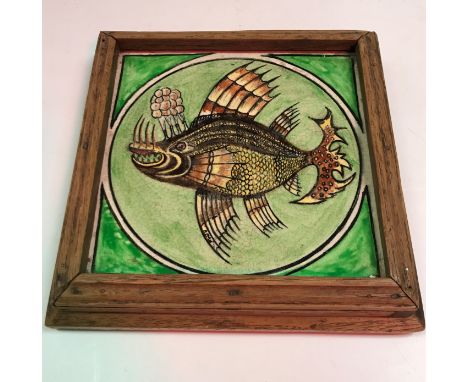 A Minton Hollins &amp; Co. glazed pottery tile decorated with an exotic fish, signed “FWOH” to the fin 15 cm square