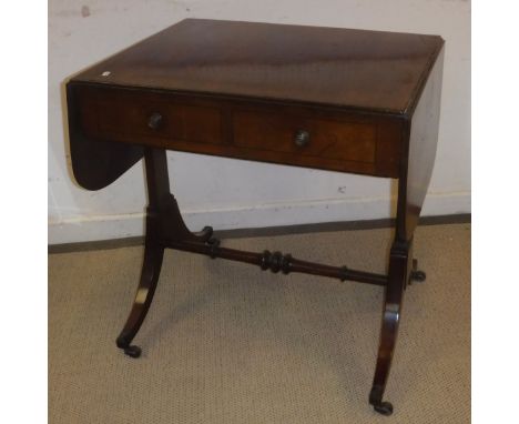 An early 19th Century mahogany and rosewood strung drop-leaf sofa table, the top with reeded edge over two frieze drawers on 