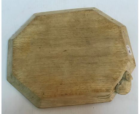 A "Mouseman" Robert Thompson of Kilburn oak cheese board of elongated octagonal form in light oak 25 cm x 30.5 cm