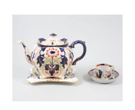 Staffordshire earthenware tea pot on stand, Japanese inspired printed decoration, height overall, 22cm; a similar teapot, Mid