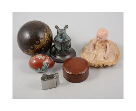 A leather and brass ringed ball, glass animal ornaments, hedgehog, penguin, rhinoceros, Zippo style lighter, porcelain doll, 