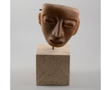 Inca death mask on a marble block plinth, overall height 40cm.