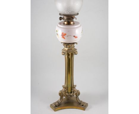 Edwardian brass tripod lamp base, adapted with a later oil lamp reservoir, shade and funnel, 85cm overall.
