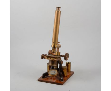 Victorian lacquered brass microscope, the lens case engraved H. Crouch, London, mahogany platform 40cm.