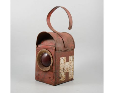 A vintage Public Work Department highway lamp, painted with H, embossed with PWD BAR and bat motif, with four red glass lense
